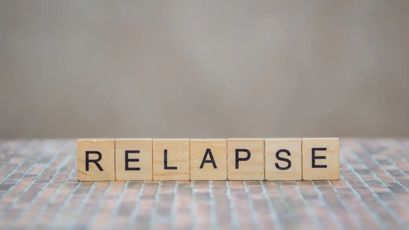 Letter blocks spell out the word "relapse" - 10 Most Common Causes Of Relapse