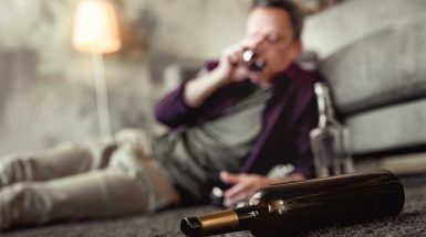 Man Binge Drinking At Home-Binge Drinking In New England