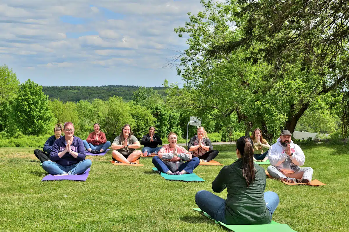 group therapy meditation session taking place on the lawn at Spring Hill - Dual Diagnosis Treatment At Spring Hill