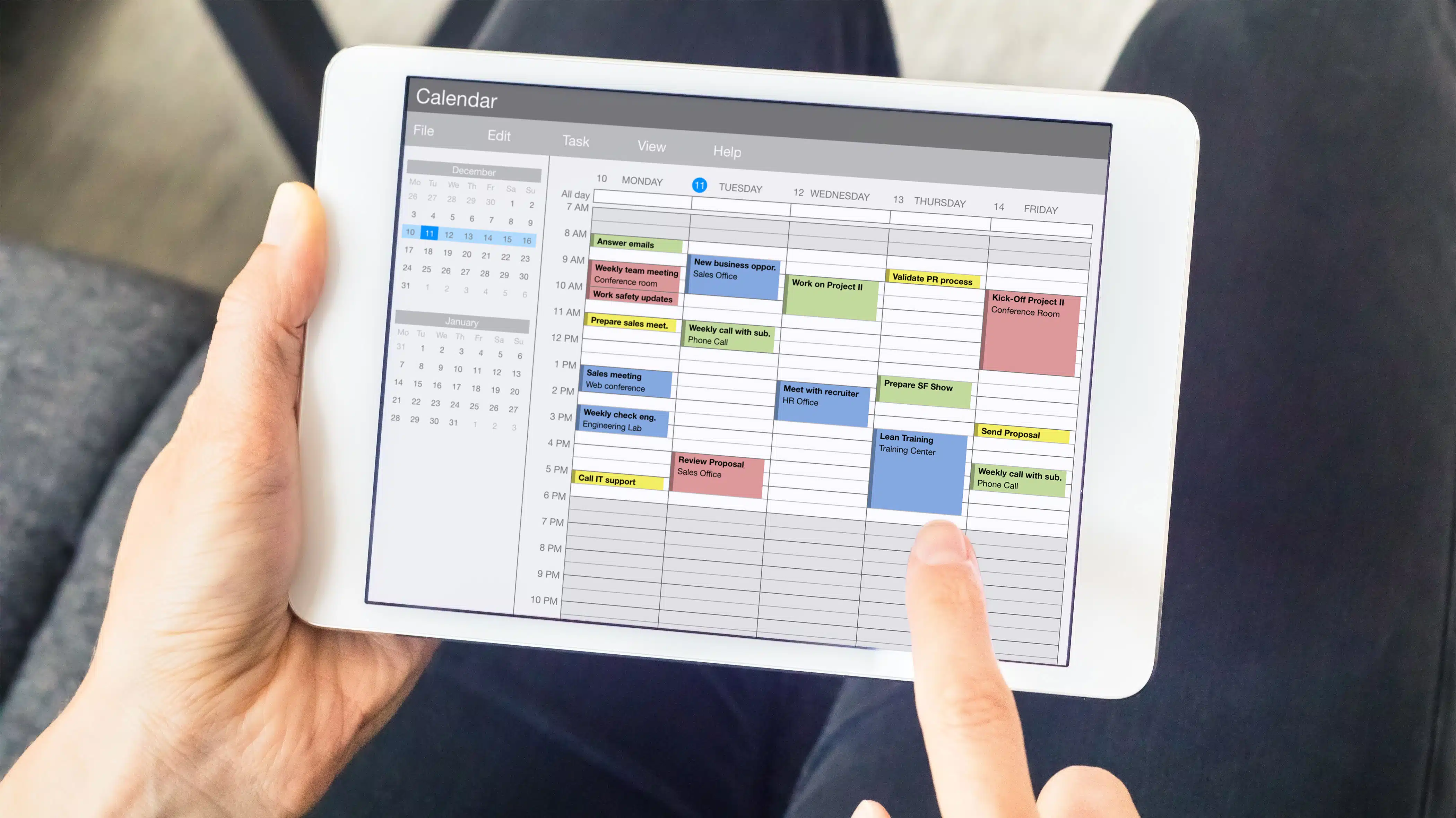 A person looks at a schedule on a tablet - Developing A Healthy Daily Routine In Recovery