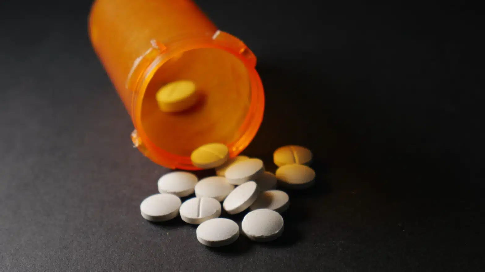 Pills spill out of an orange bottle - How Fentanyl Has Changed Opioid Use Disorder Treatment