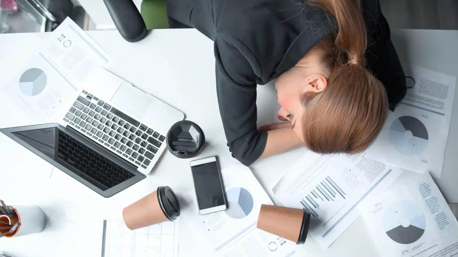 A tired woman rests her head on her work desk - Sobriety Fatigue What It Is And How To Manage It